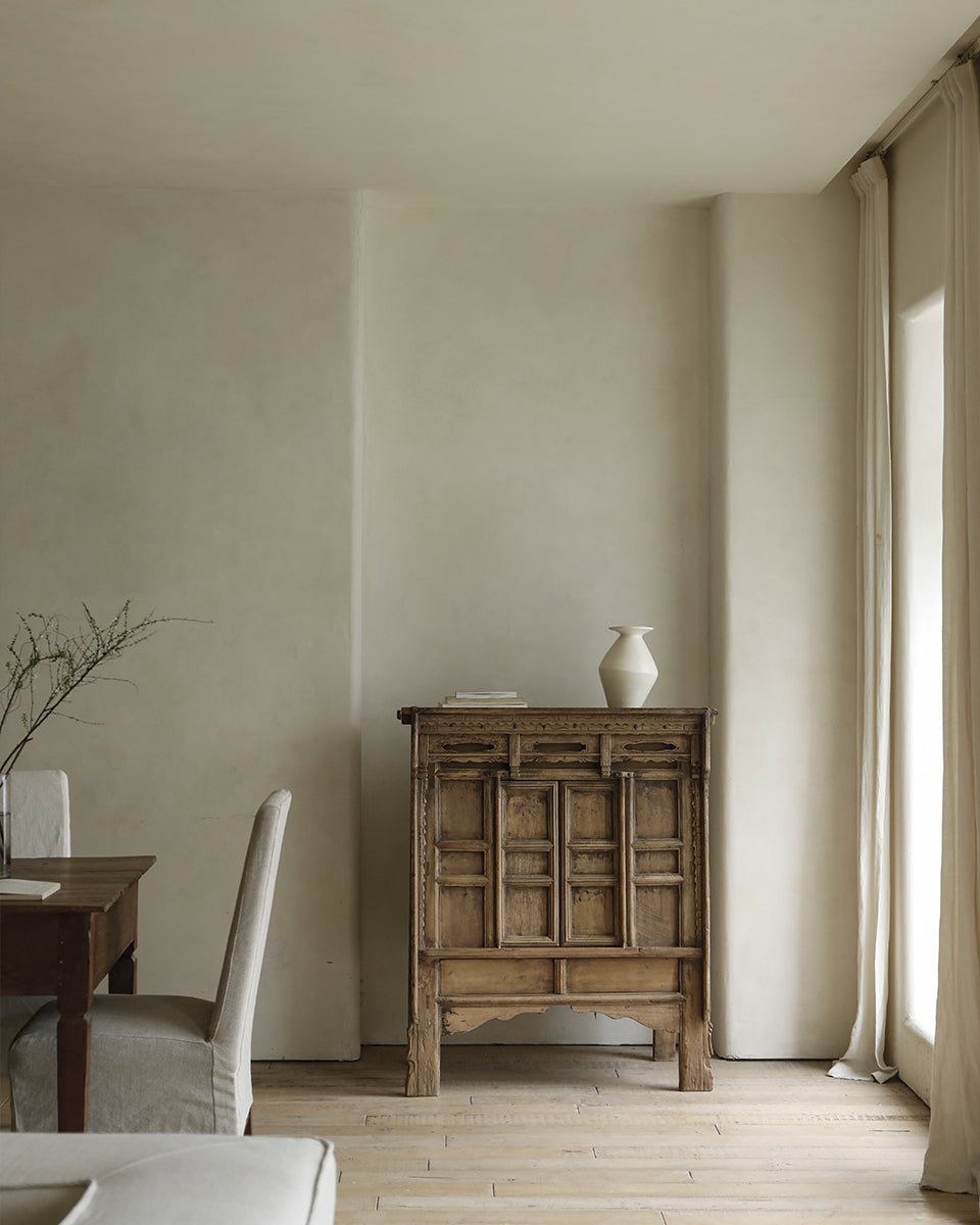 Chinese cabinet in warm wooden tones, offering versatile storage with detailed paneling and reclaimed materials.