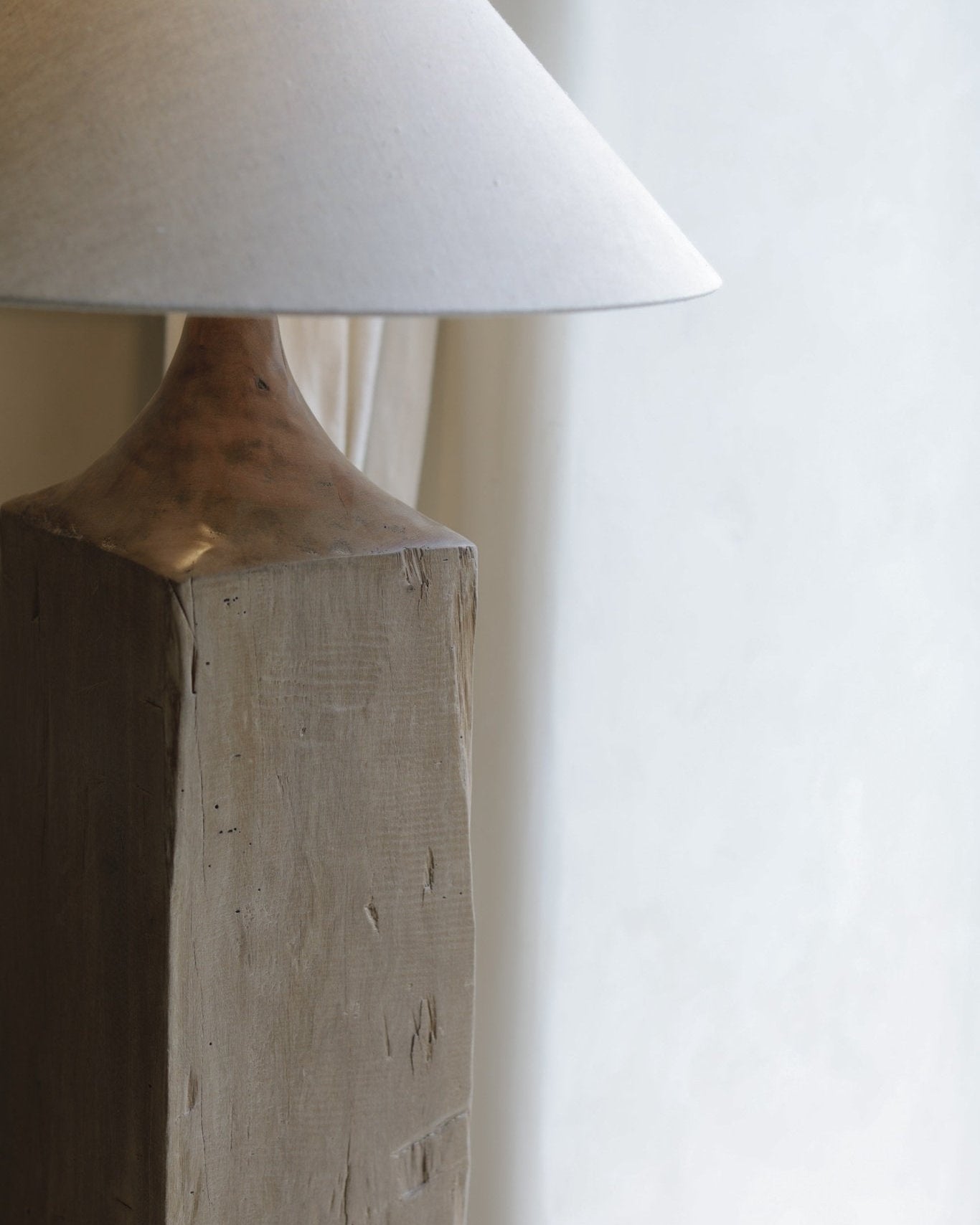 Close-up of a wooden floor lamp base and linen shade. Chinese Plug Type A. Minimalist wooden lamp for cozy lighting.