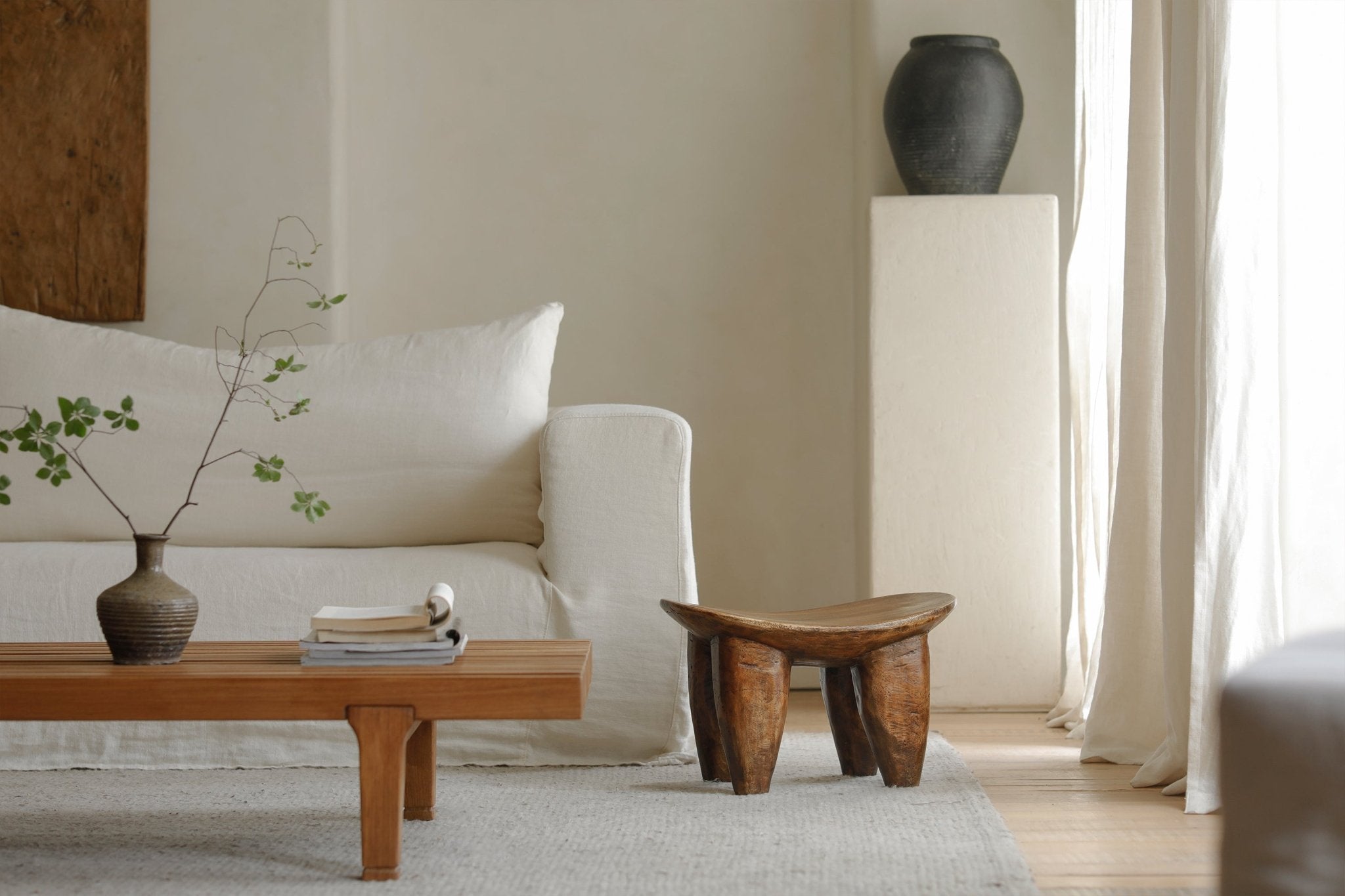 Milk stool made of Samanea saman wood, natural finish in living room setting