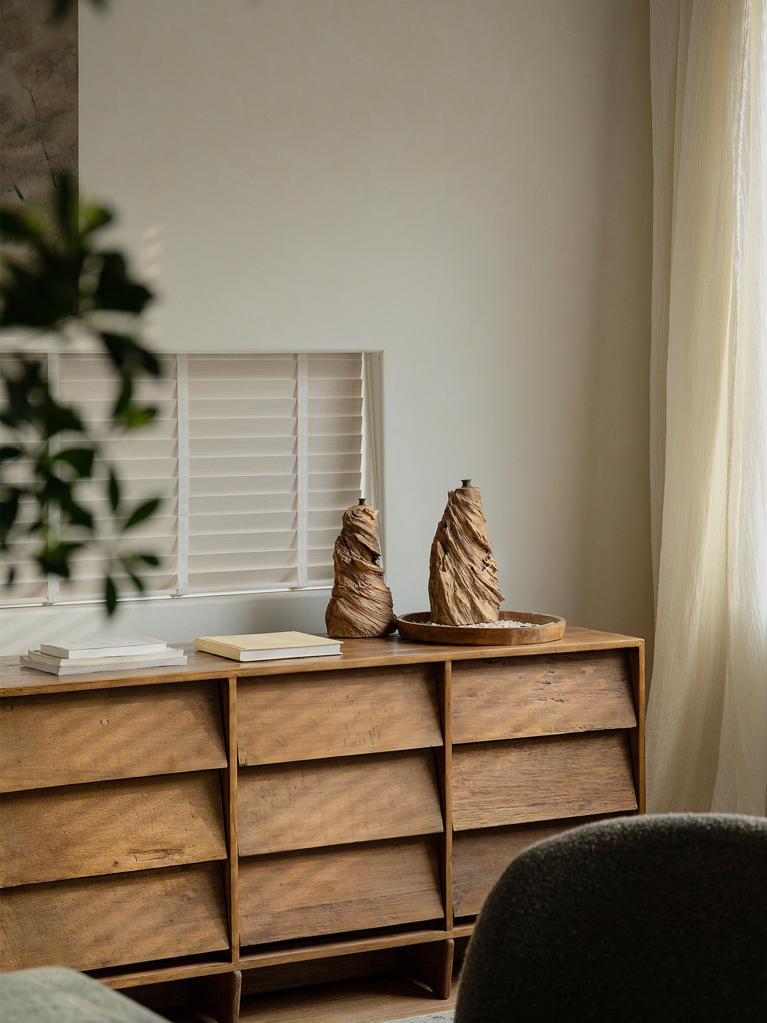 Wavy wooden vases displayed on a wooden cabinet, perfect for home decor. Handcrafted vases with natural wood grain.