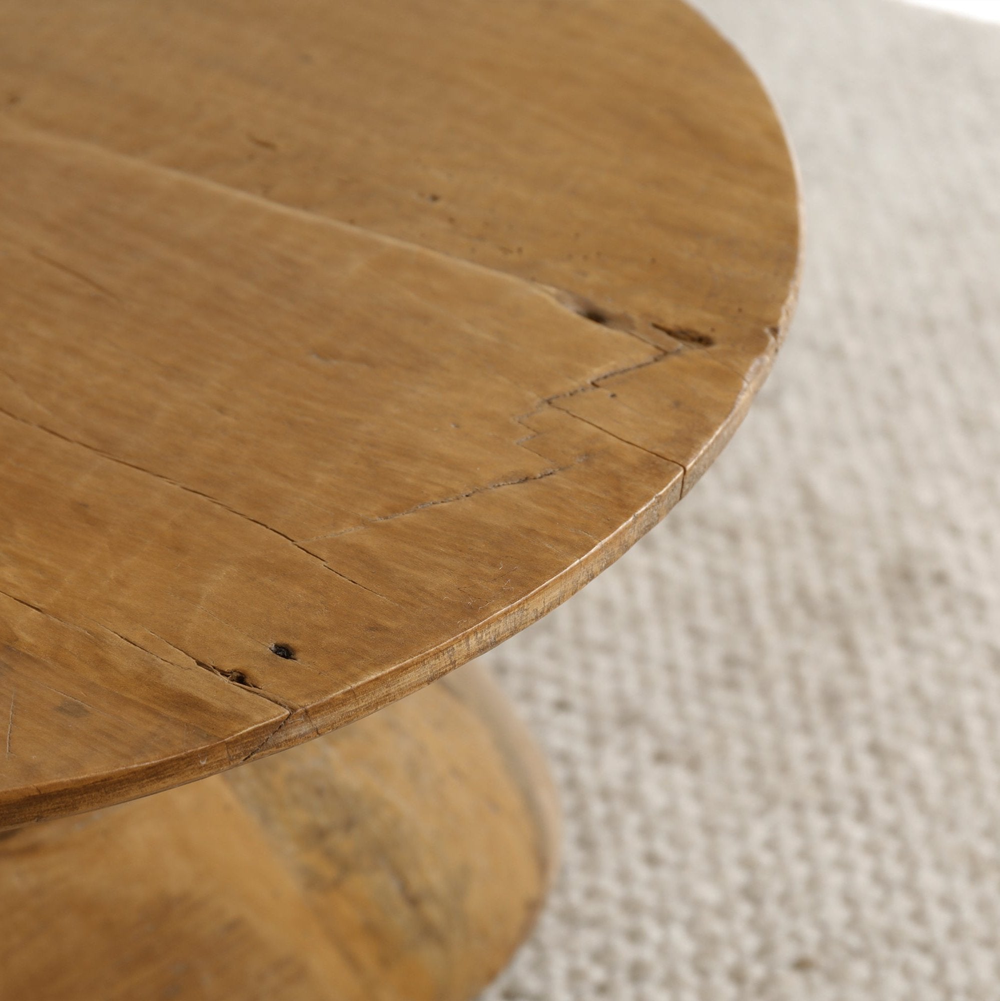 Alva Side Table detail: natural wood surface, distorted base, organic design, and curved surfaces.