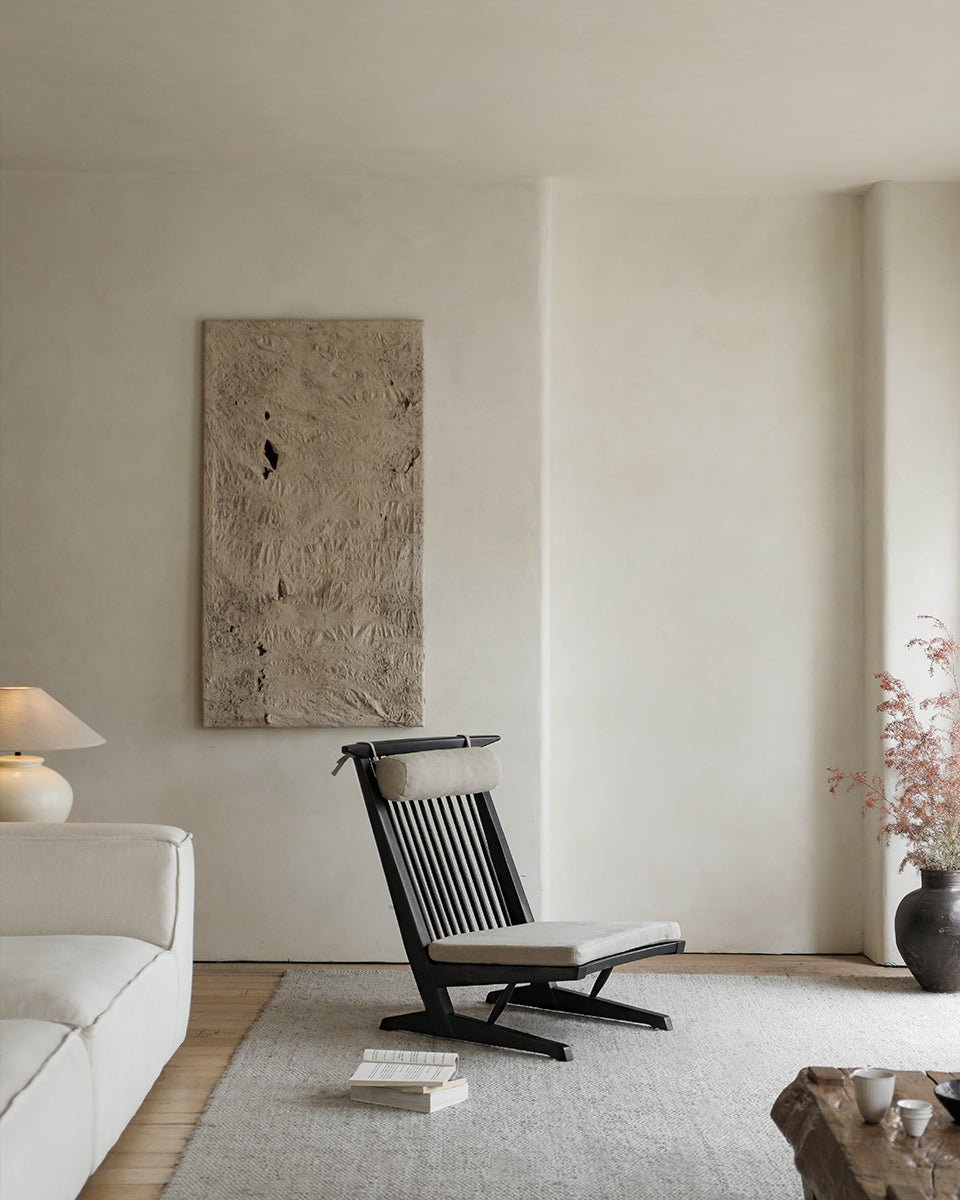 George Lounge Chair in black teak wood with light cushion, modern interior design.