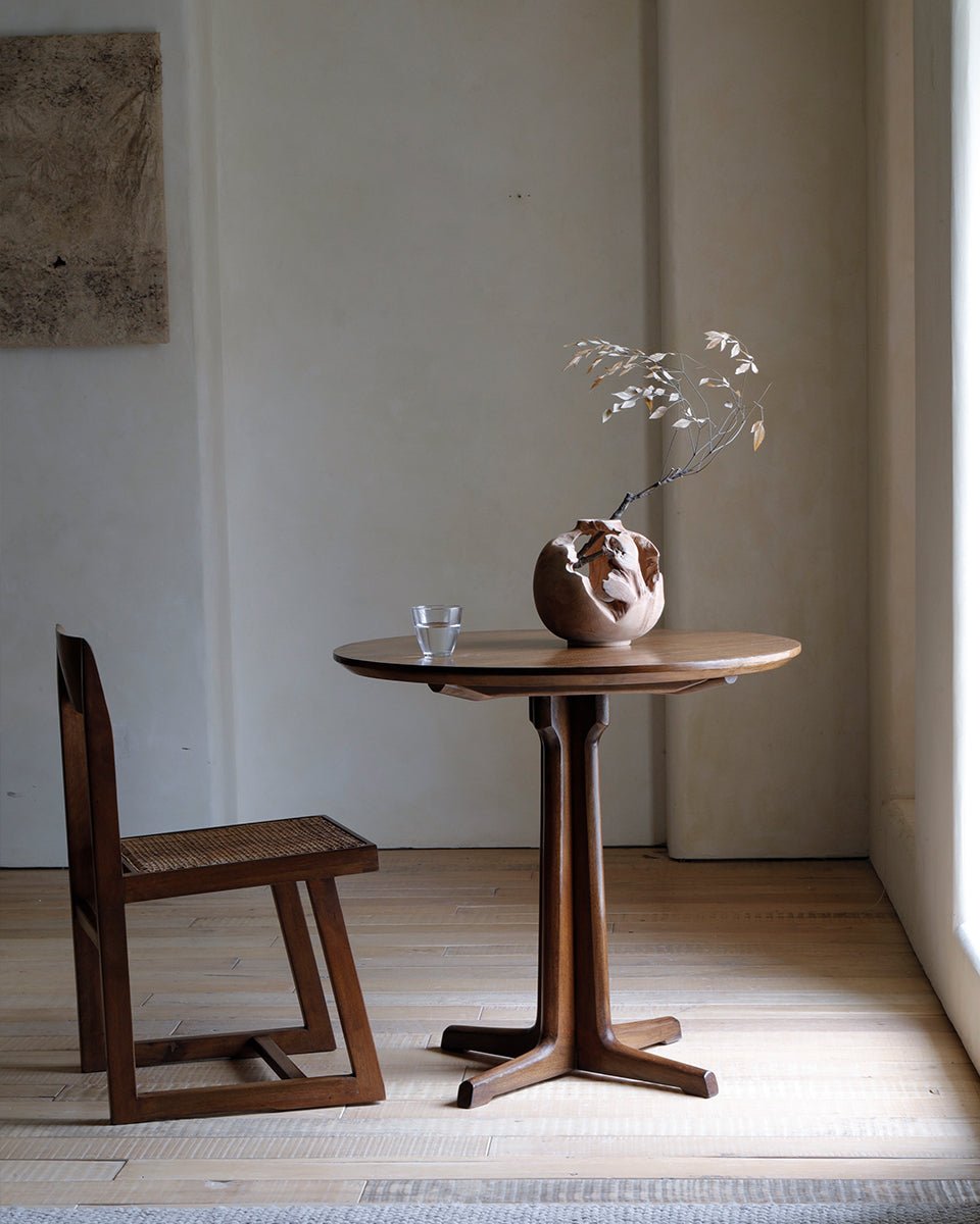 Elegant X Table with wooden chair, showcasing space-saving design and natural wood finish, perfect for small spaces.