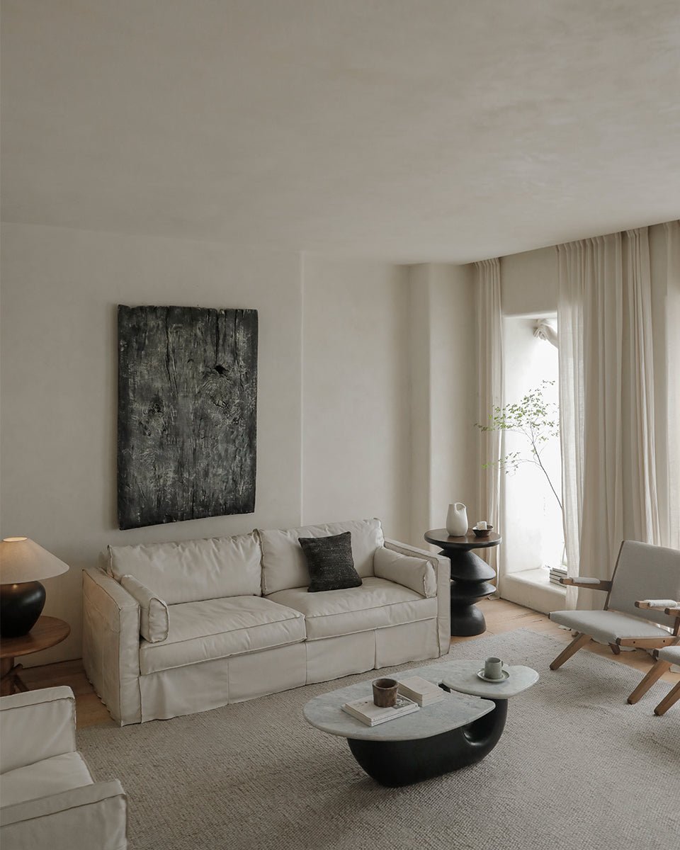 Cream Skirt Leather Sofa in Modern Living Room with Marble Coffee Table and Art