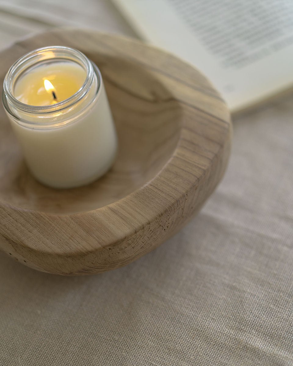 Indonesian teak wooden platter with lit candle and book, decorative display, handmade.