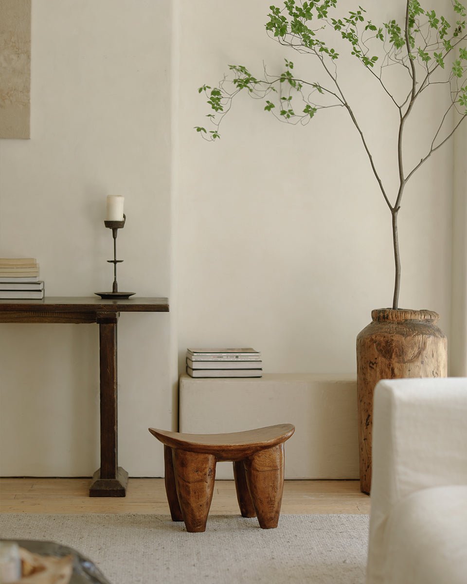 Samanea saman wood milk stool in a minimalist living room setting, natural finish, perfect decor.