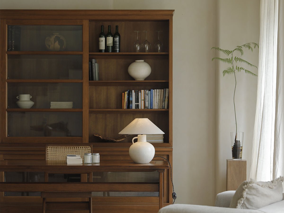 African teak glass bookcase with wine, books and lamp display, an elegant storage solution