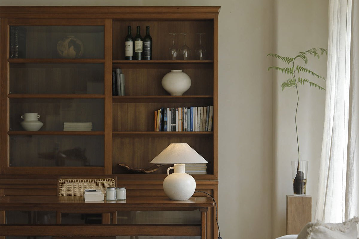 African teak glass bookcase with wine, books and lamp display, an elegant storage solution