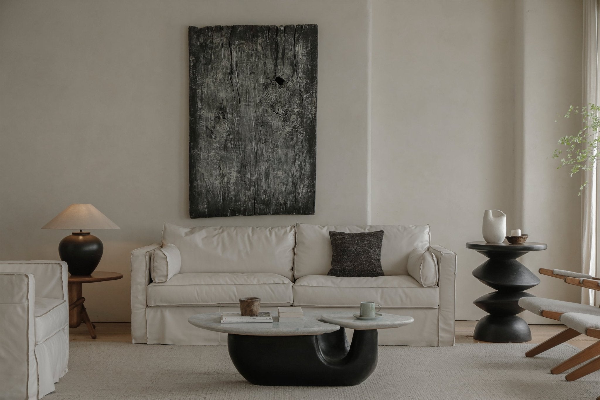 Cream Skirt Leather Sofa in a modern living room setting, with marble coffee table and artwork.