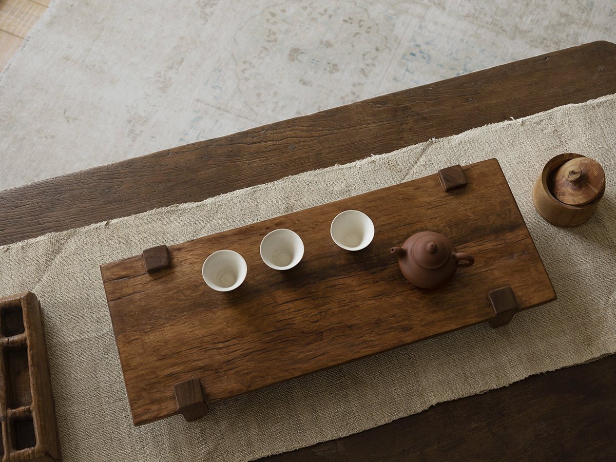 Chinese tea tray set with teapot and cups on reclaimed wood, rustic design