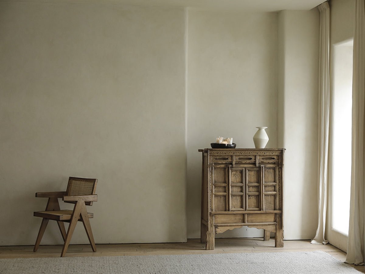 Chinese cabinet made with reclaimed materials in a bright room, offering versatile storage and a touch of nostalgia.