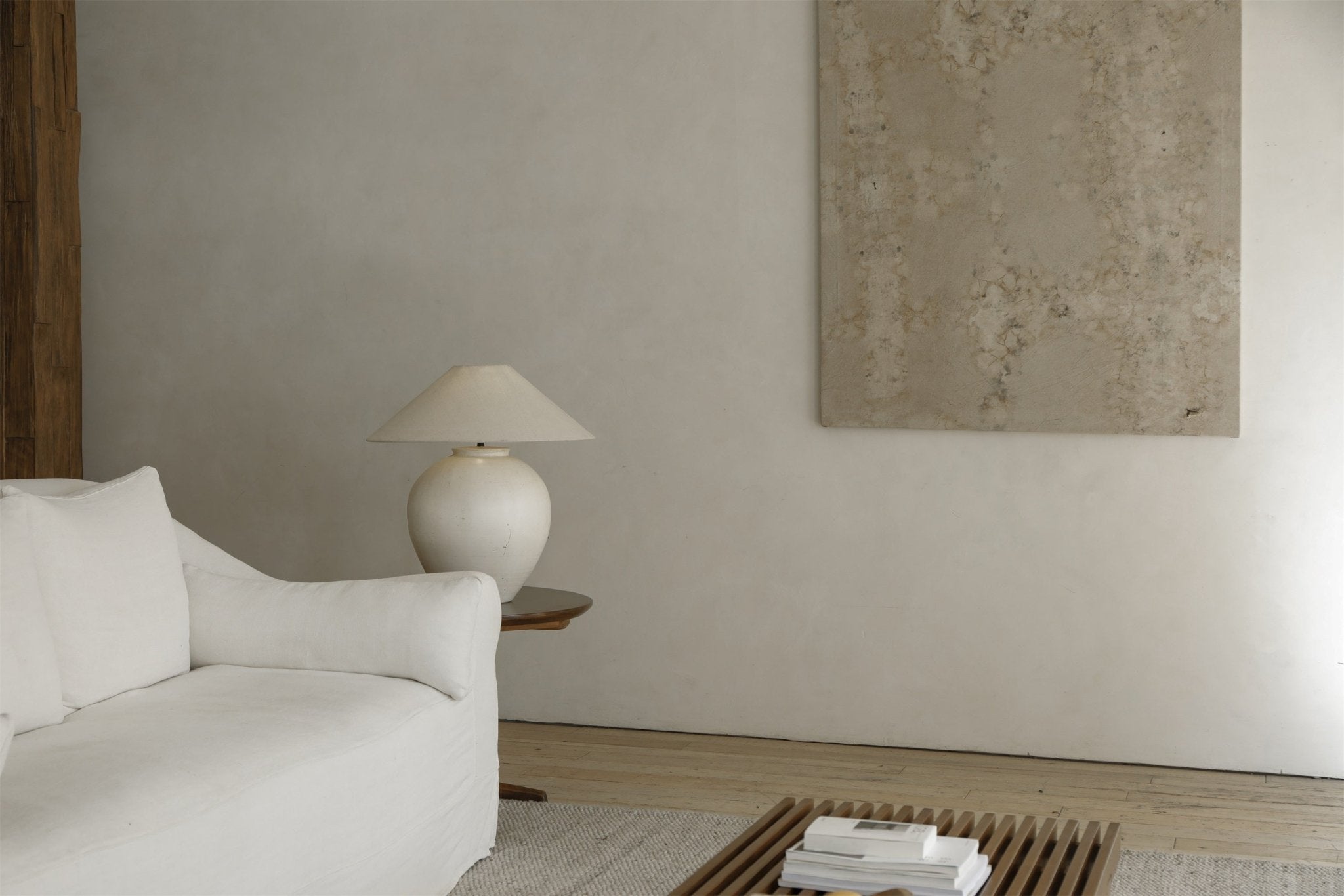 White clay Egg Lamp on a wooden side table beside white sofa, interior decor, clay material