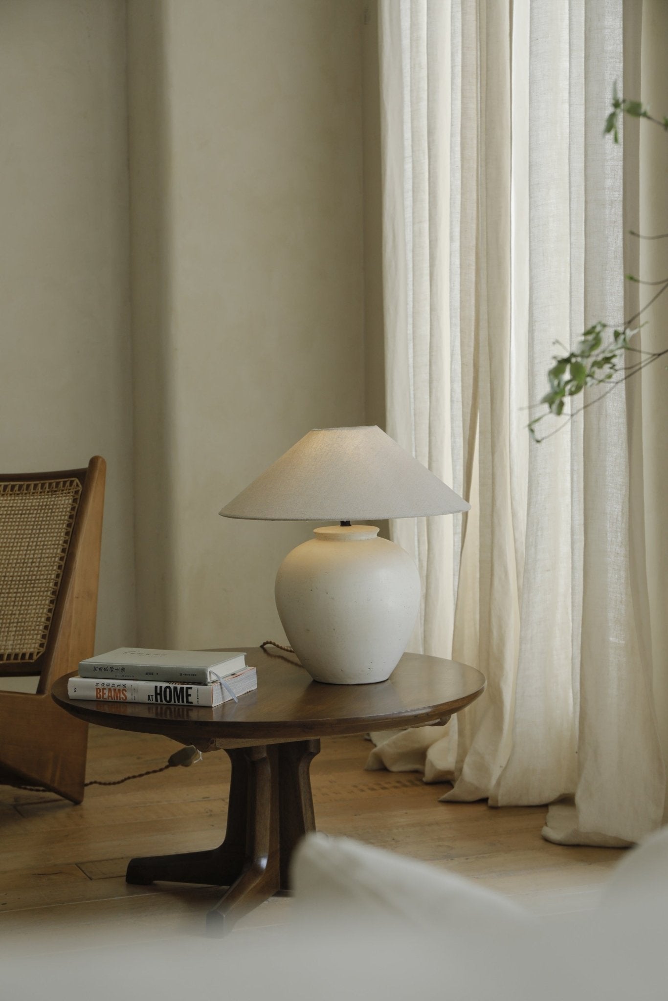 White clay Egg Lamp on wooden side table, BEAMS AT HOME books, modern interior decor