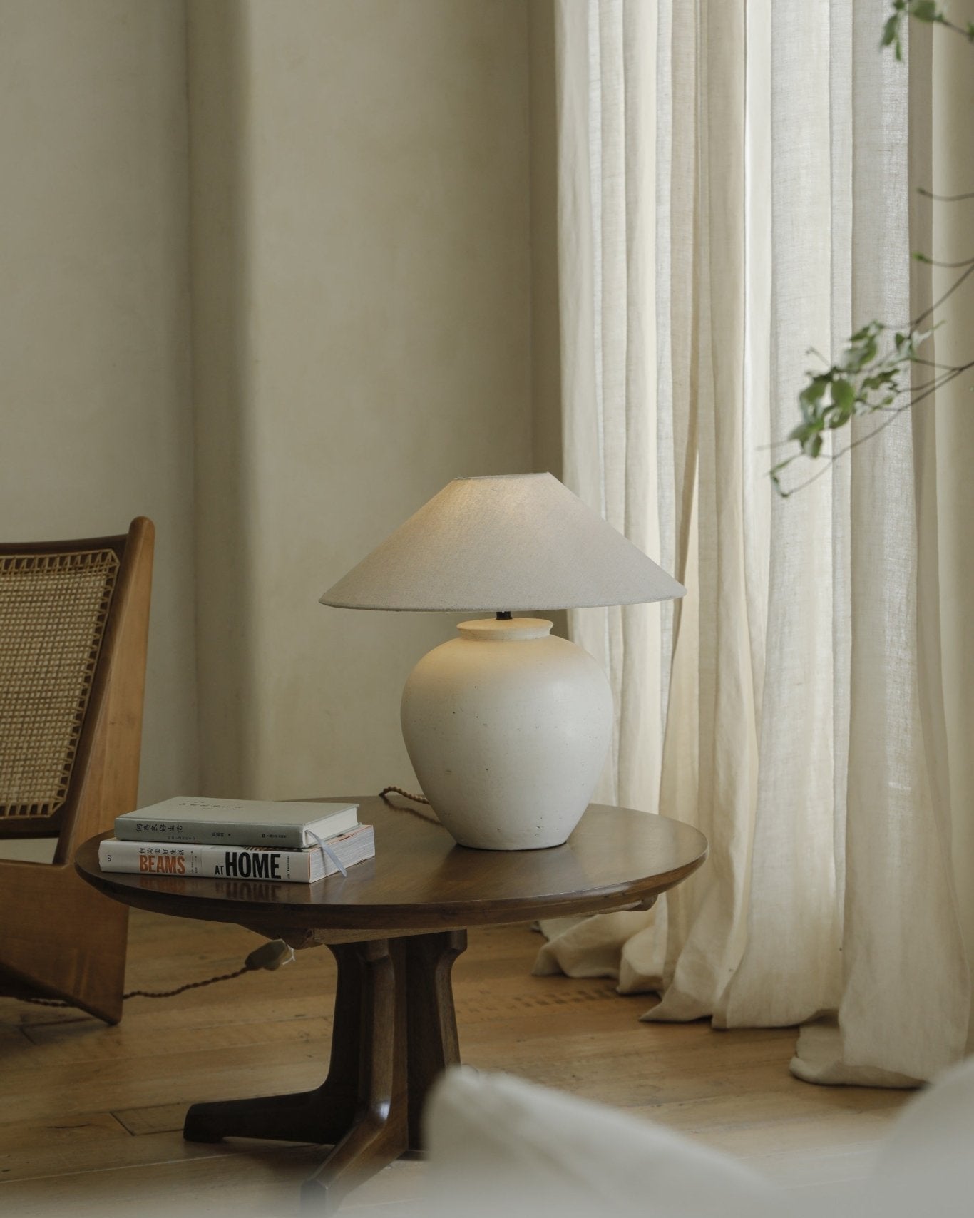 White clay Egg Lamp on wooden side table, BEAMS AT HOME books, modern interior decor