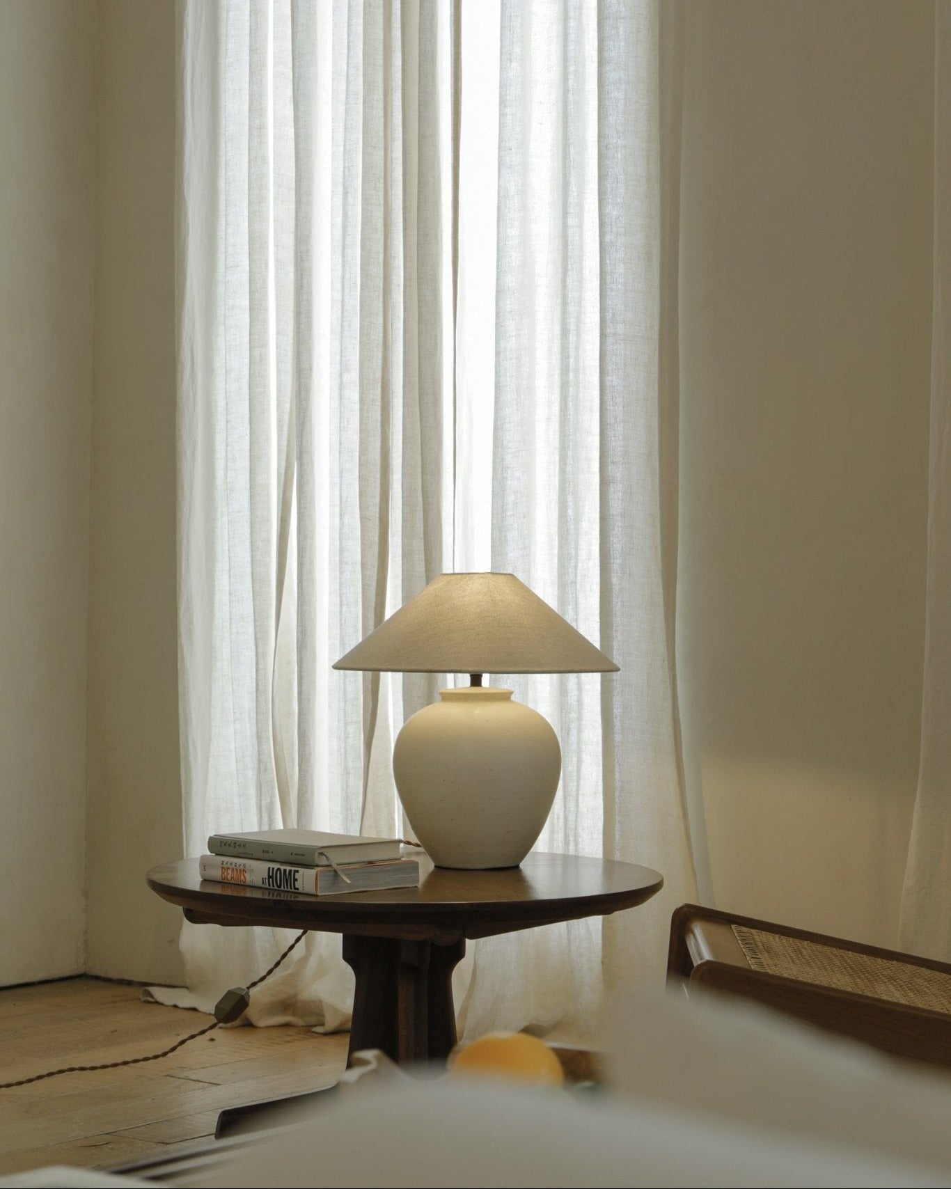 Clay Egg Lamp on wooden table with BEAMS AT HOME books, interior decor