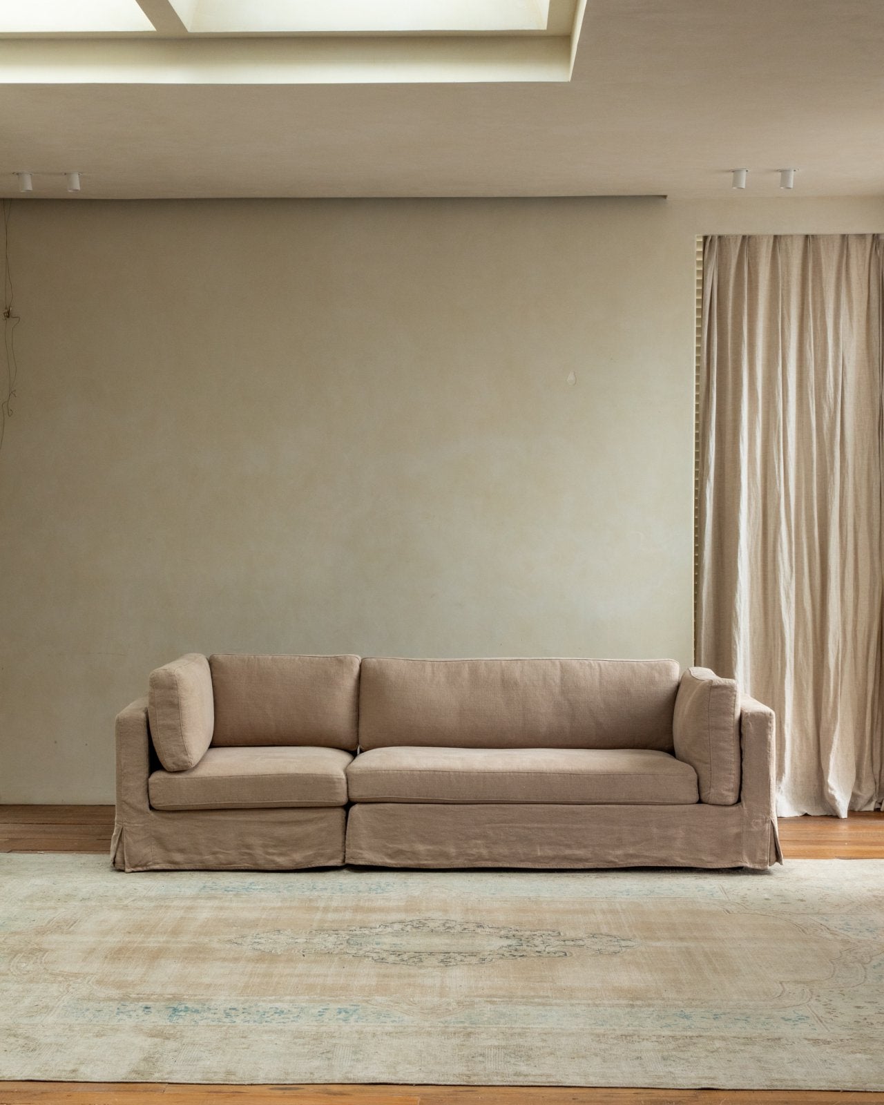Skirt Sectional Sofa in beige linen, modular design for customizable comfort.