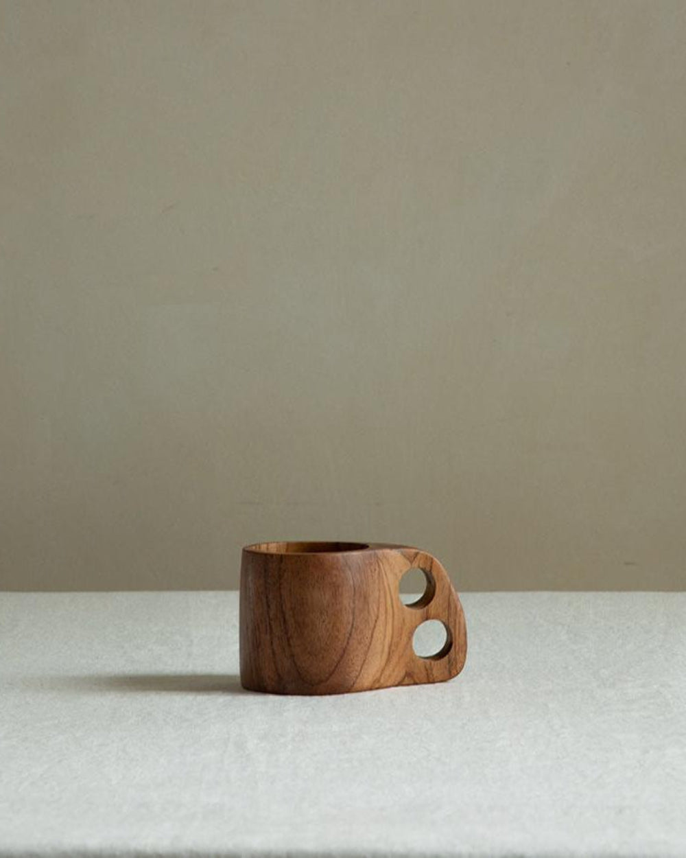 Handmade teak wood double hole cup, showing natural wood grain and carved design, ideal for home decor.