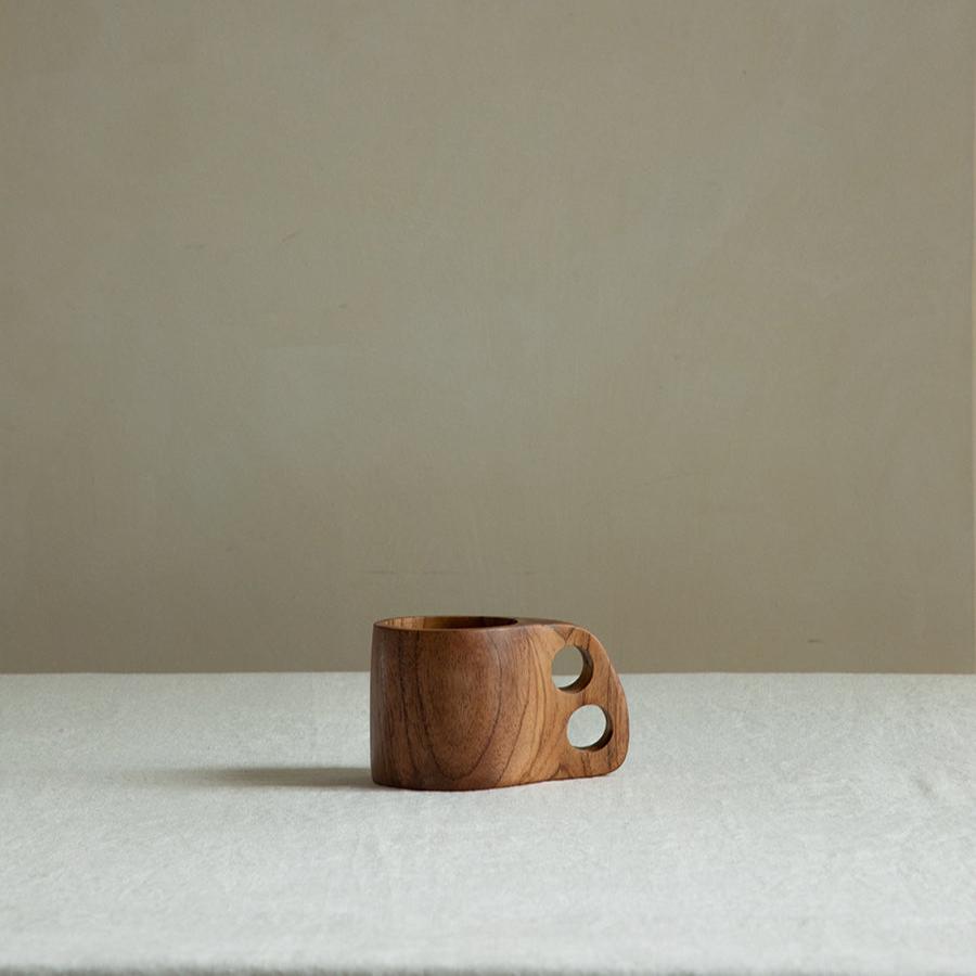 Handmade teak wood double hole cup, showing natural wood grain and carved design, ideal for home decor.