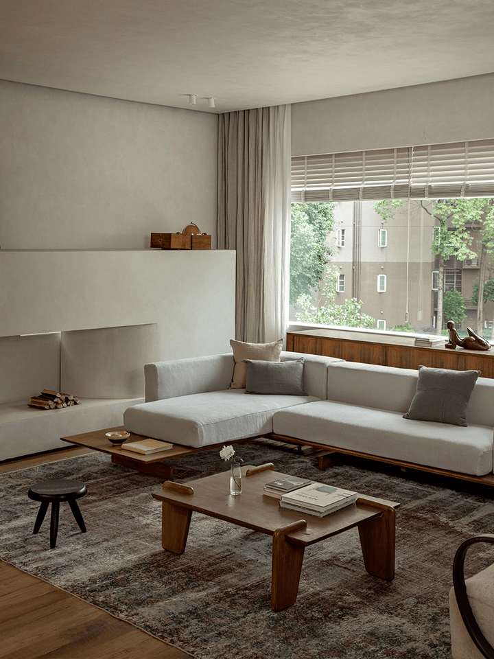 Linen modular sofa with teak base in a serene living room with wooden coffee table.