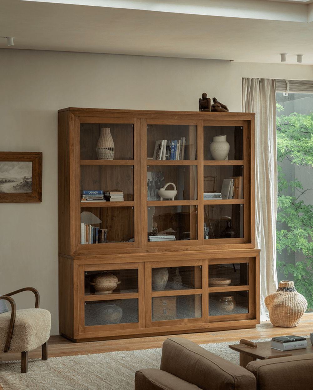 Teak wood glass front bookcase with sliding glass doors, perfect for storage and display.
