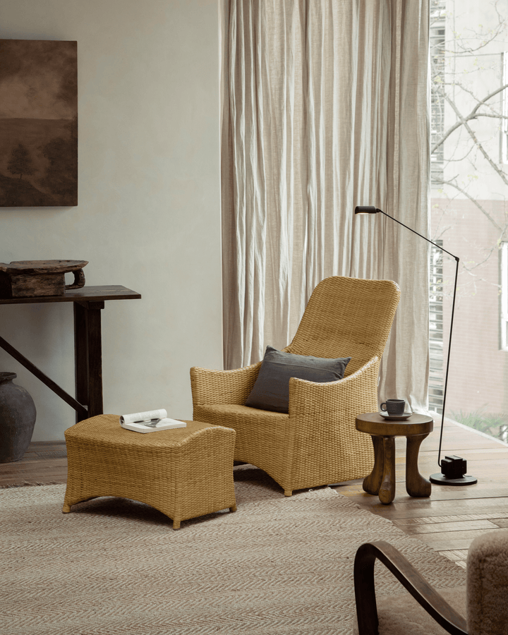Quincy stool in a cozy living room with wicker chair and natural decor