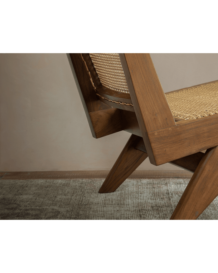 Chandigarh Armless Easy Chair close-up showcasing teak wood and woven rattan details.