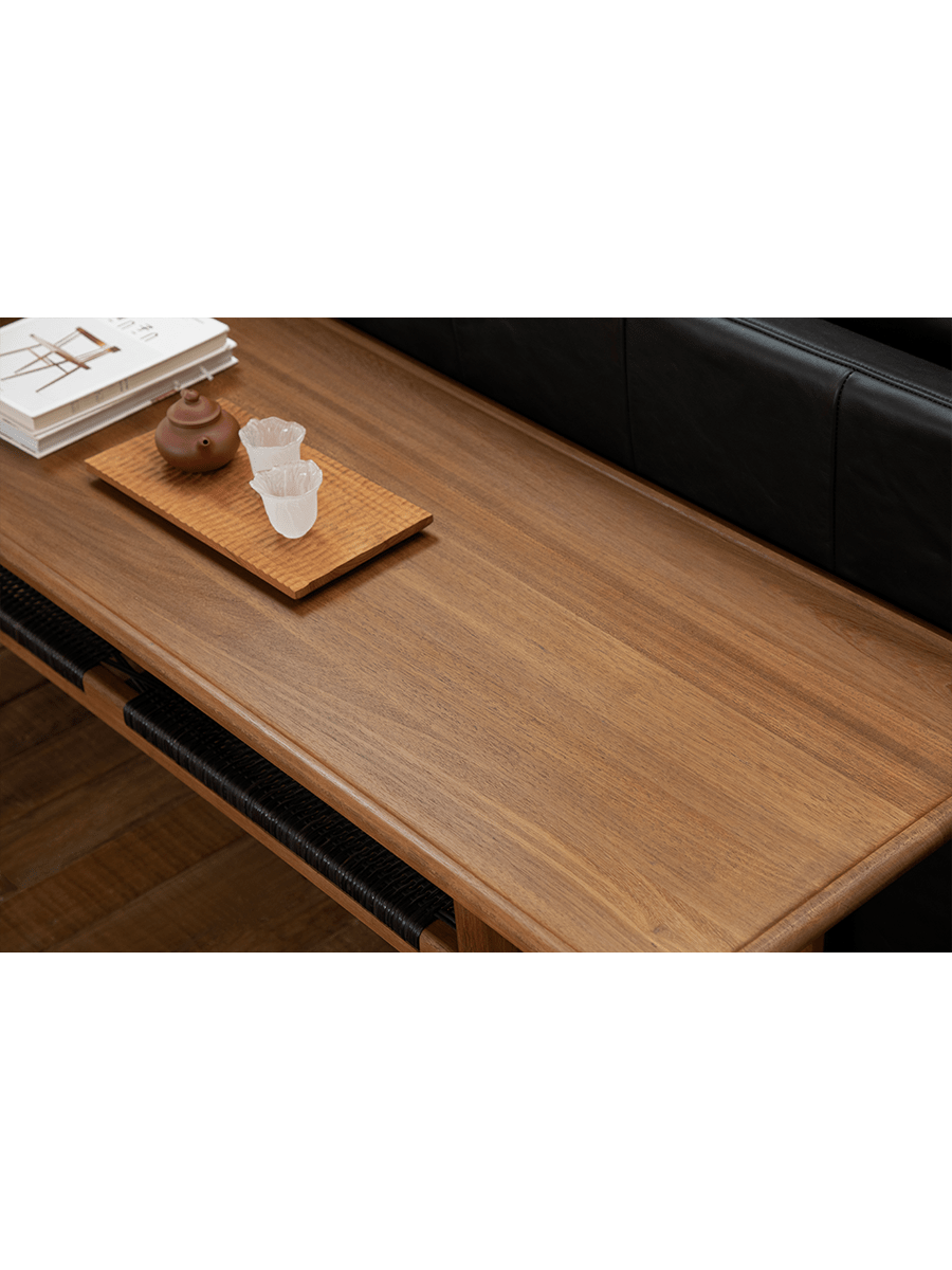 Hans Accent Table detail showcasing the wooden surface, tea set and woven black shelf