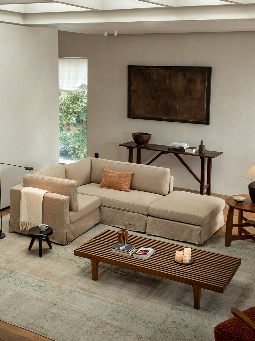 Beige linen skirt sectional sofa in modern living room with modular design and relaxed atmosphere