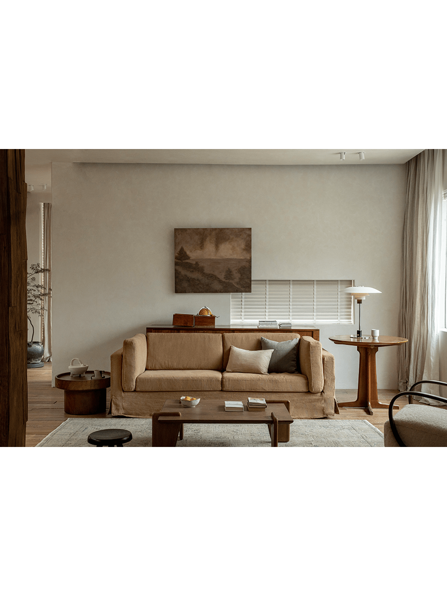 Tan Skirt Linen Sofa in a modern living room setting with wooden furniture and rug. Creating a peaceful atmosphere.