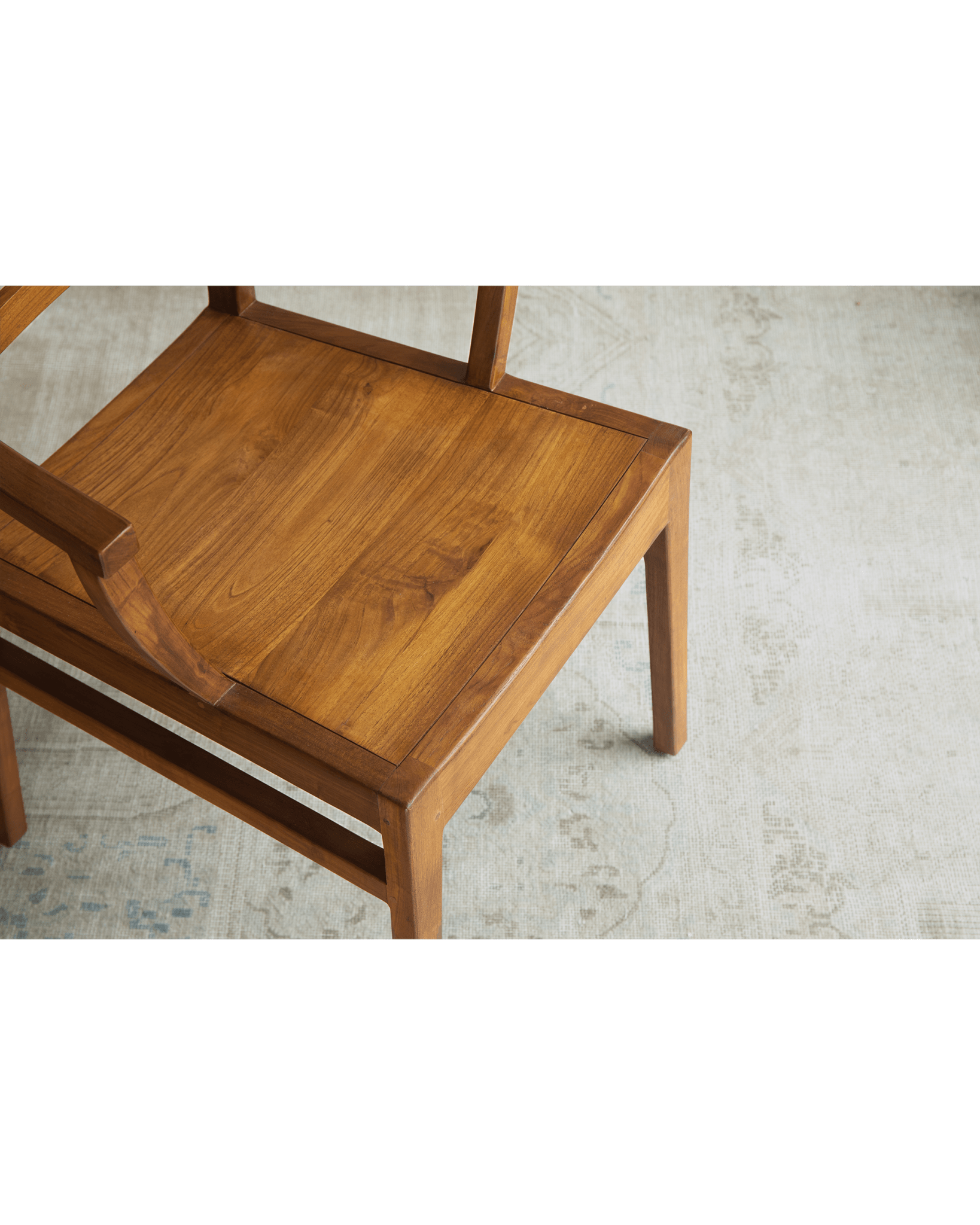 Hug Chair, wooden chair with warm wood tones and sleek design, showcasing its solid wood construction and comfortable form.