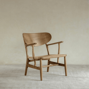 CH22 Lounge Chair in oak with woven paper cord seat. Danish design icon for modern and Scandinavian interiors.