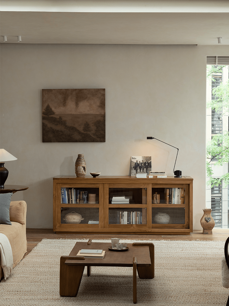 Teak wood glass front bookcase in a stylish living room setting