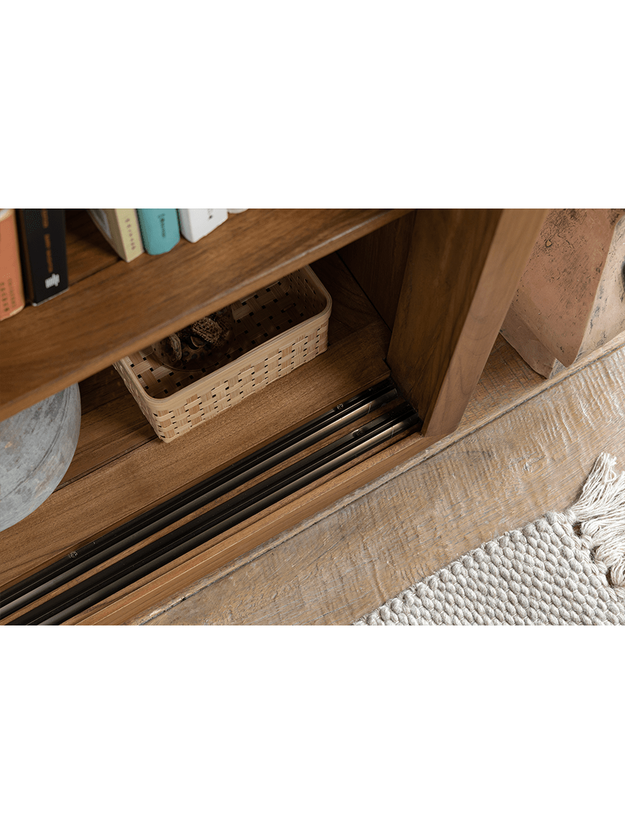 Teak wood Glass Front Bookcase sliding door track detail with natural wood grain and woven basket storage