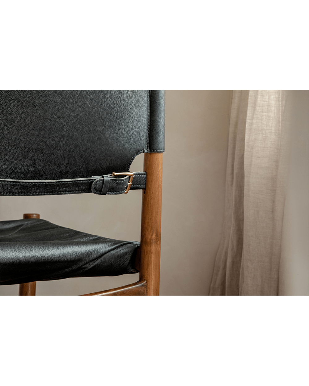 Spanish Dining Chair detail: Black leather seat and back, teak wood frame with adjustable buckle, durable design