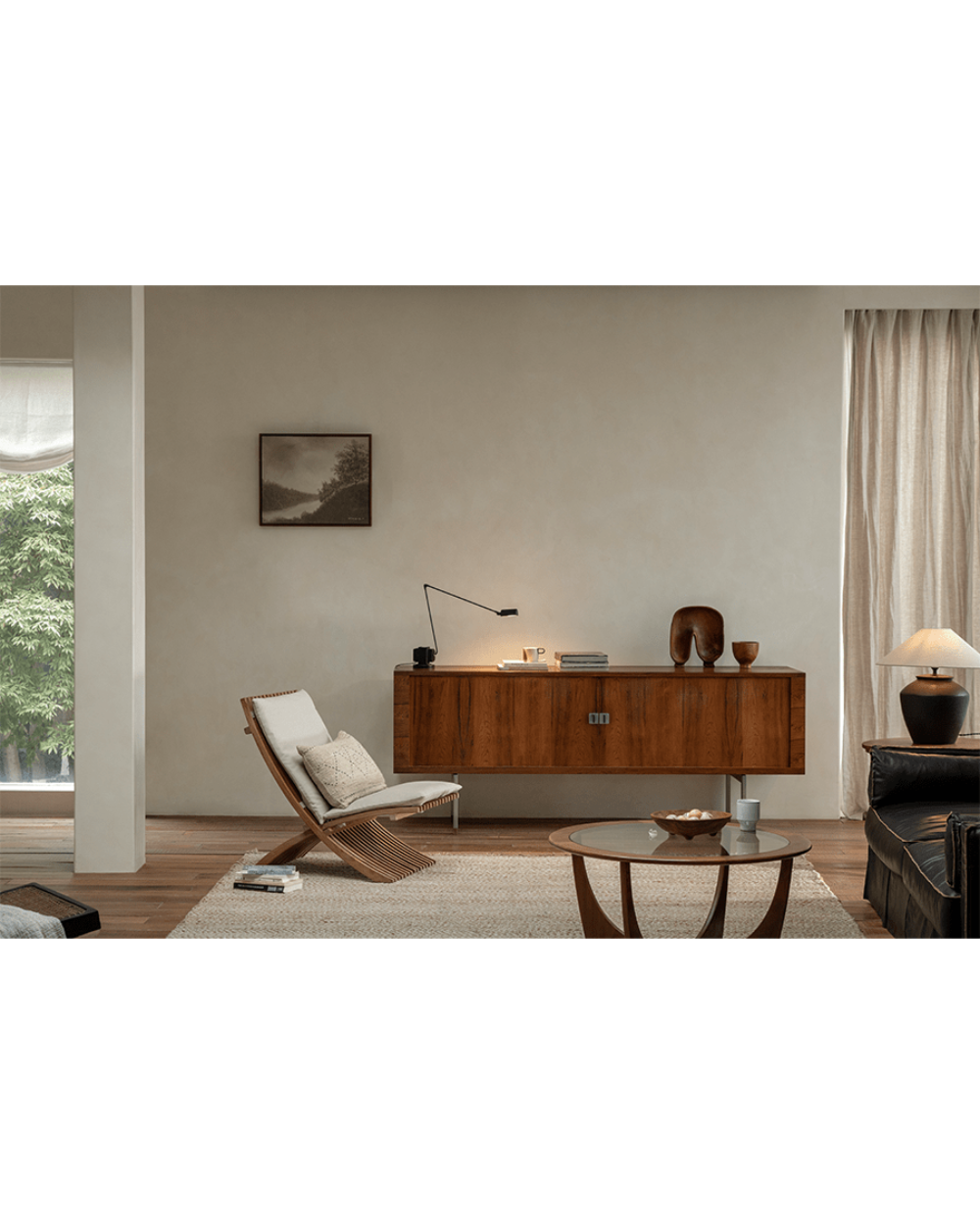 Oly Lounge Chair in a modern living room setting, showcasing the wooden slatted design, ergonomic seating, and cream cushion