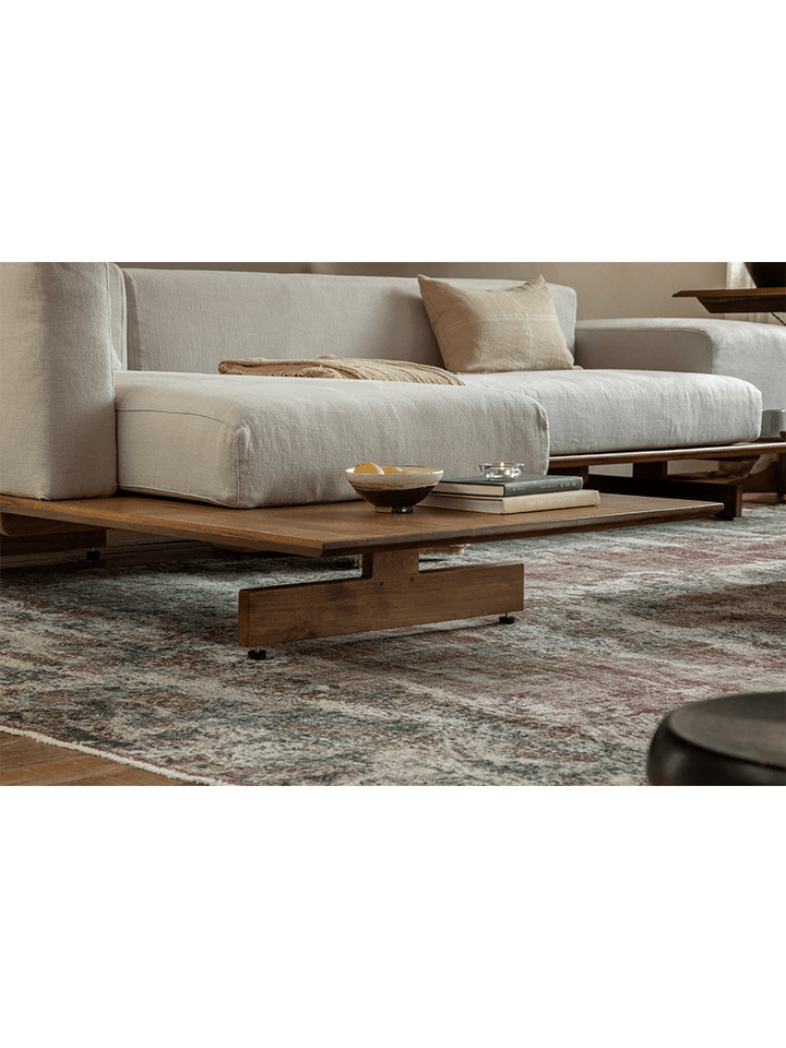 Modern linen modular sofa with teak base in a cozy living room setting