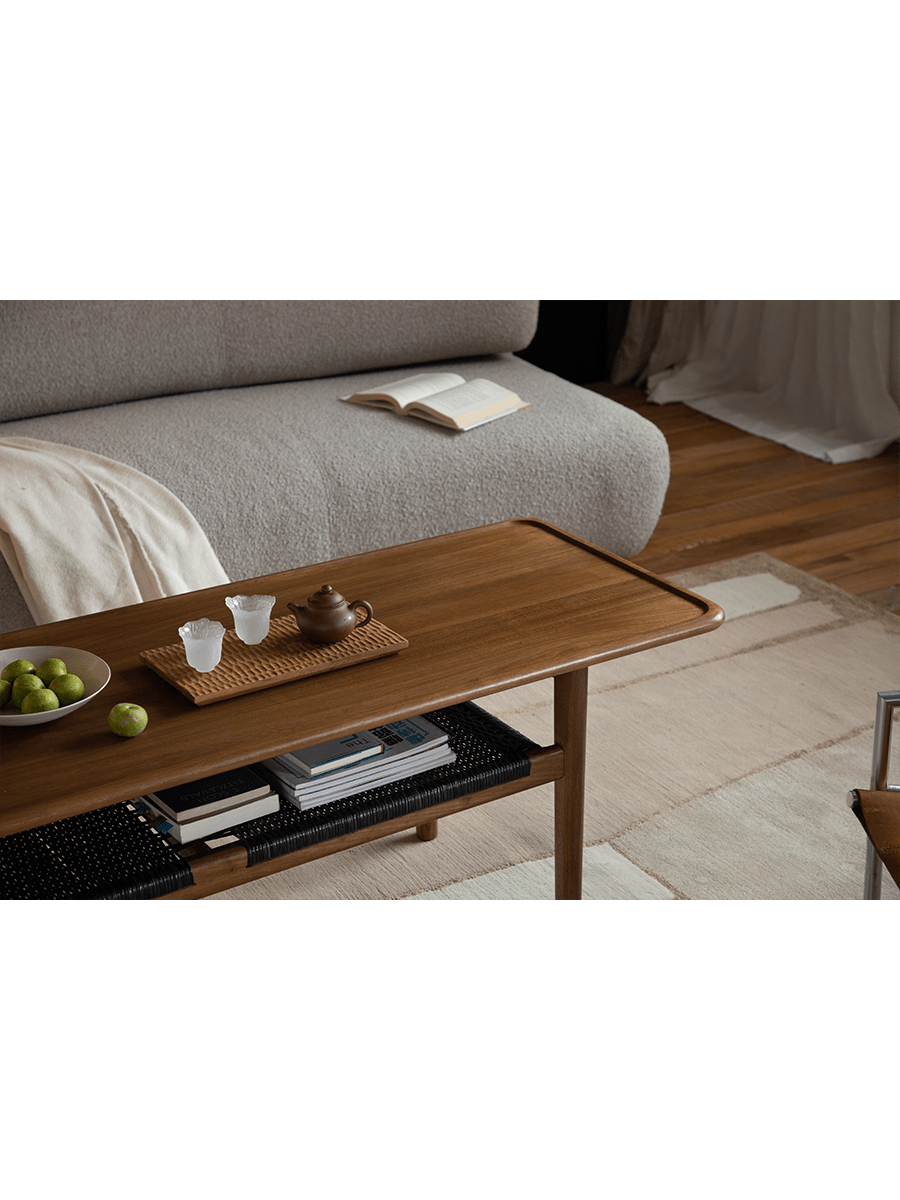 Hans Accent Table in a modern living room setting with tea set and woven shelf.