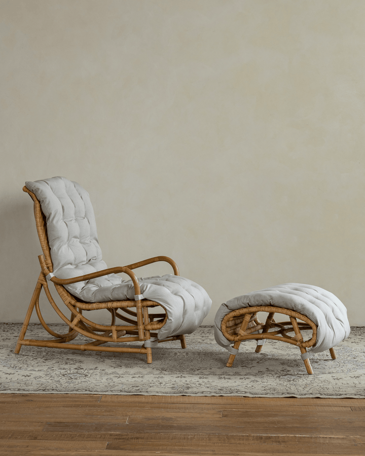 Nalgae rattan lounge chair with soft cushion and matching ottoman in a serene room
