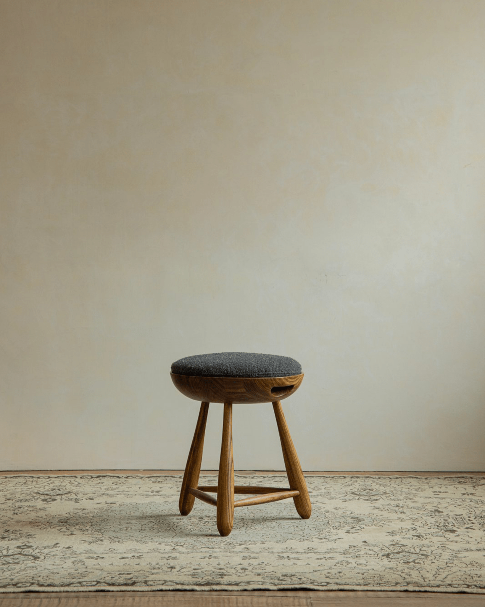 Mocho Stool in zebrawood with gray cushioned seat. Modern organic design.
