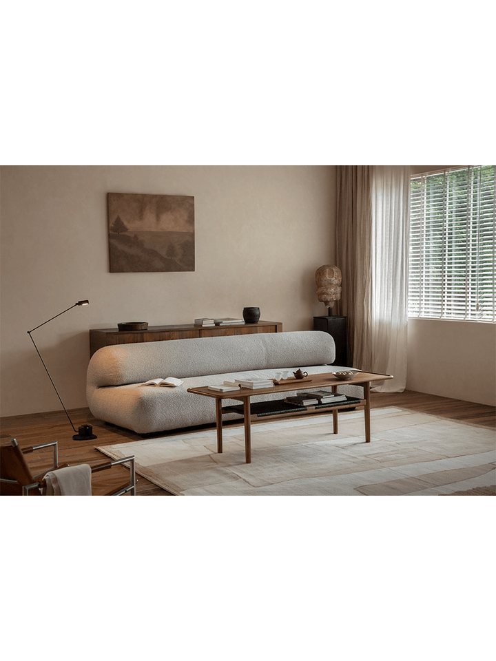 Contemporary living room featuring a sleek wooden accent table and minimalist sofa.