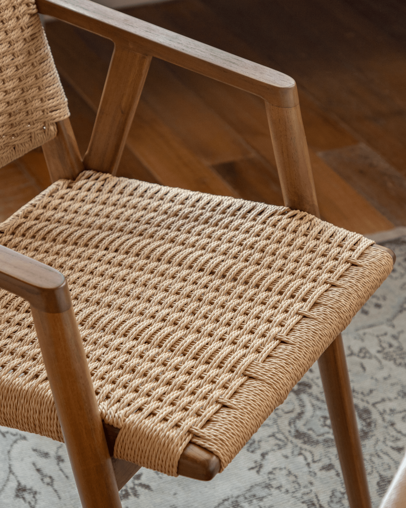 Louisa Chair close-up: woven seat and teak frame, Mid-Century Modern design. Perfect for study or dining.