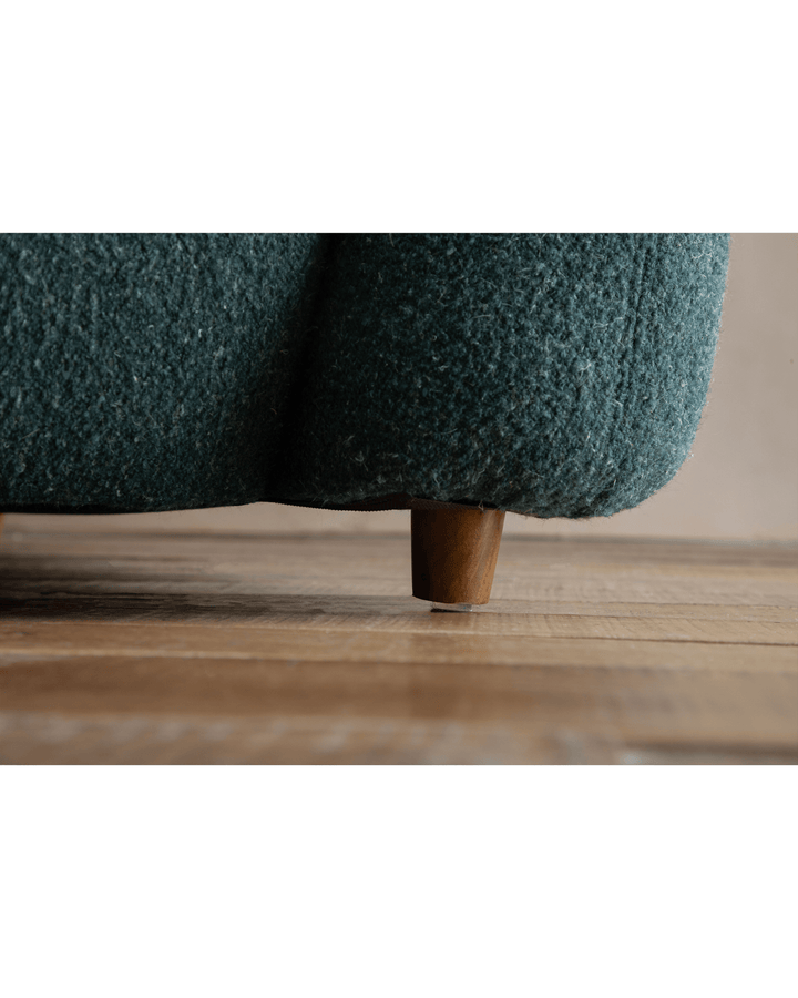 Teal Gestein Bouclé Armchair leg on wooden floor, highlighting soft texture and craftsmanship.