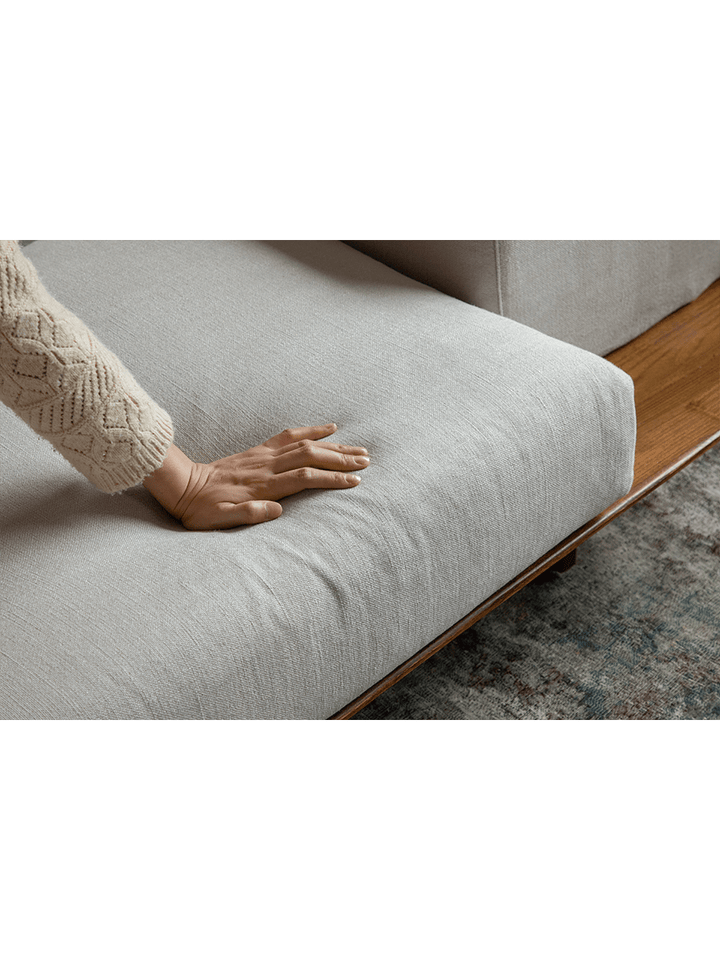Close-up of soft linen cushion on modular sofa showcasing comfort and texture.