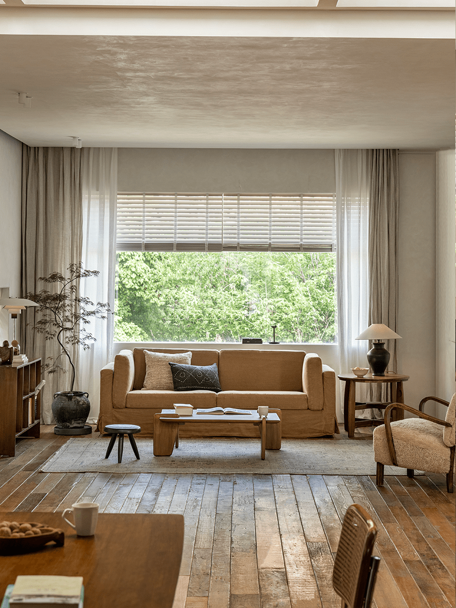Skirt Linen Sofa in a cozy living room setting, with wooden furniture and neutral tones. Creating a peaceful atmosphere.