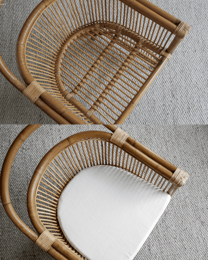 View of Cape Chair's rattan frame and linen cushion from above in a bright space.
