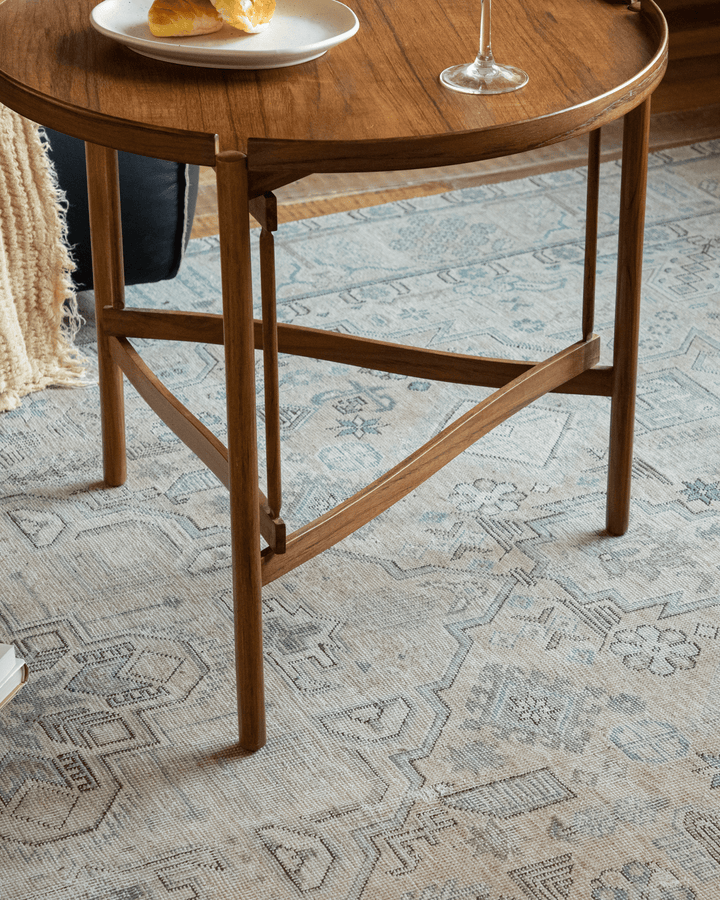Hansen Tray Side Table with croissants and wine glass in cozy living room setting.