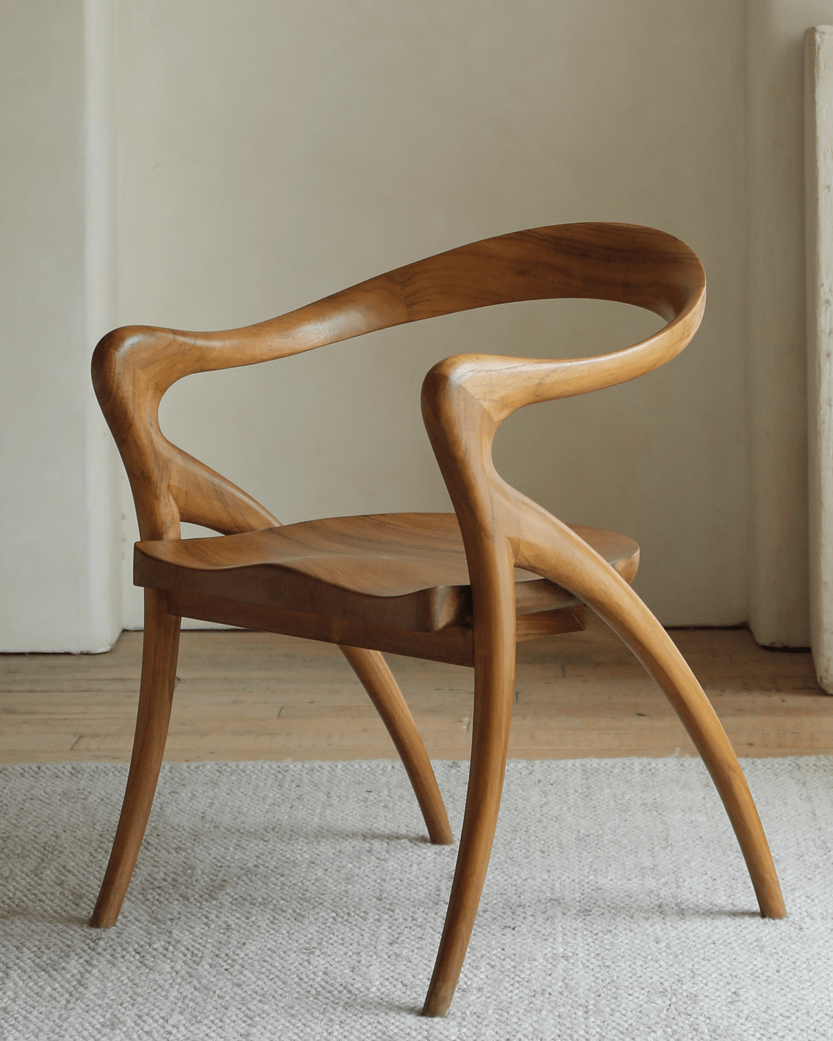 Olivia Chair in solid teak wood. Curved backrest, contoured seat and tapered legs for modern design.