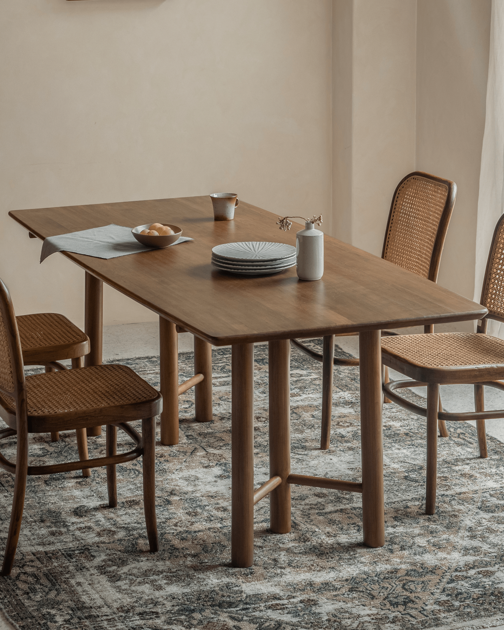 Columna Cherry Wood Dining Table with chairs, showing red cherry wood details and modern design for dining.
