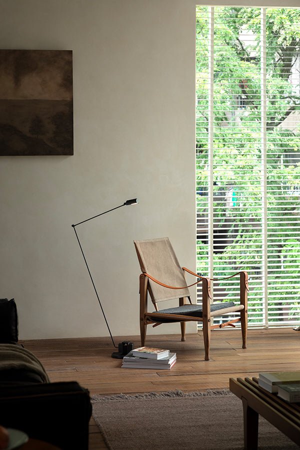 Safari Chair in a stylish living room setting, featuring wood, leather, and canvas materials