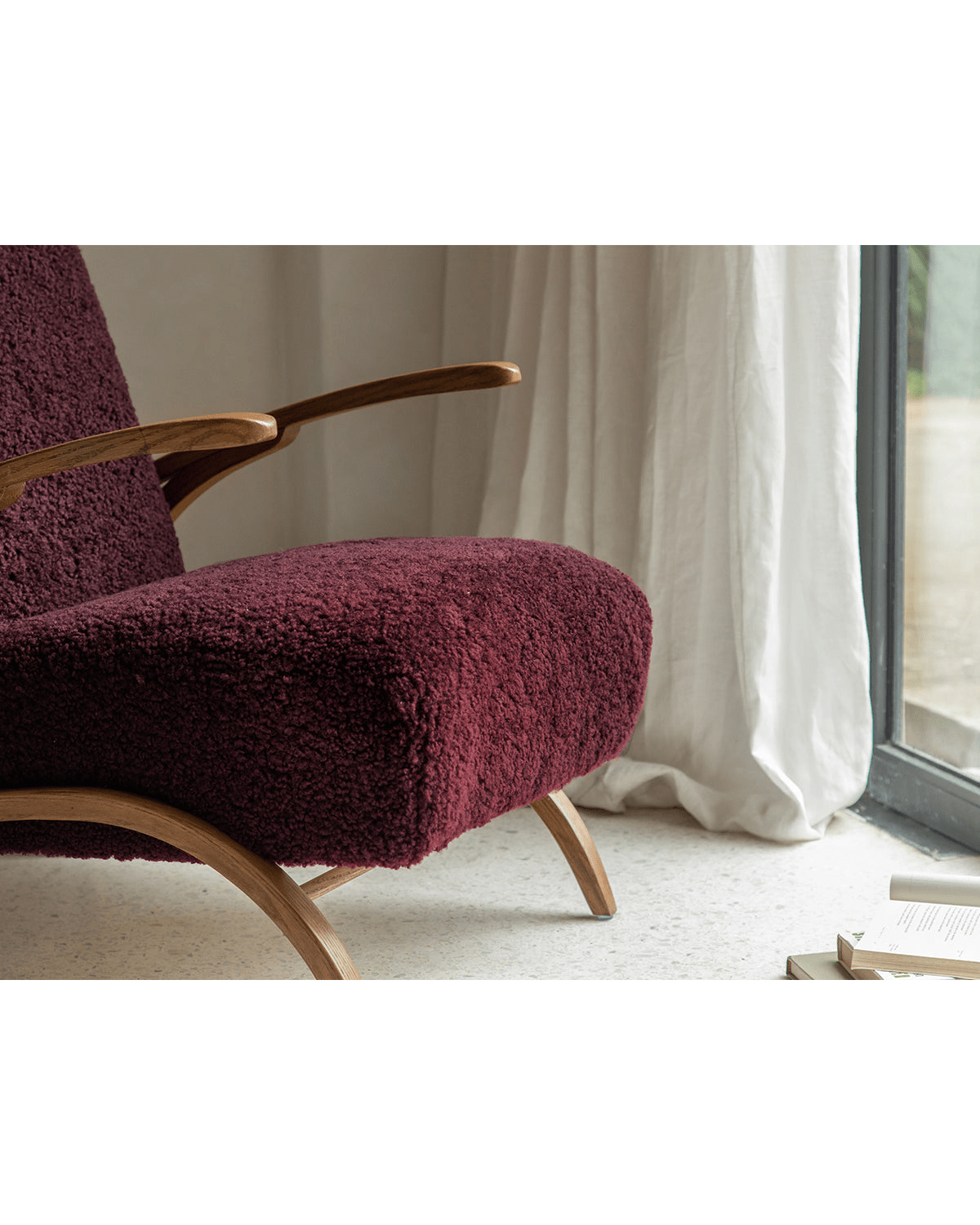 Nebula Lounge Chair in burgundy shearling with red oak frame, showcasing cozy mid-century modern design